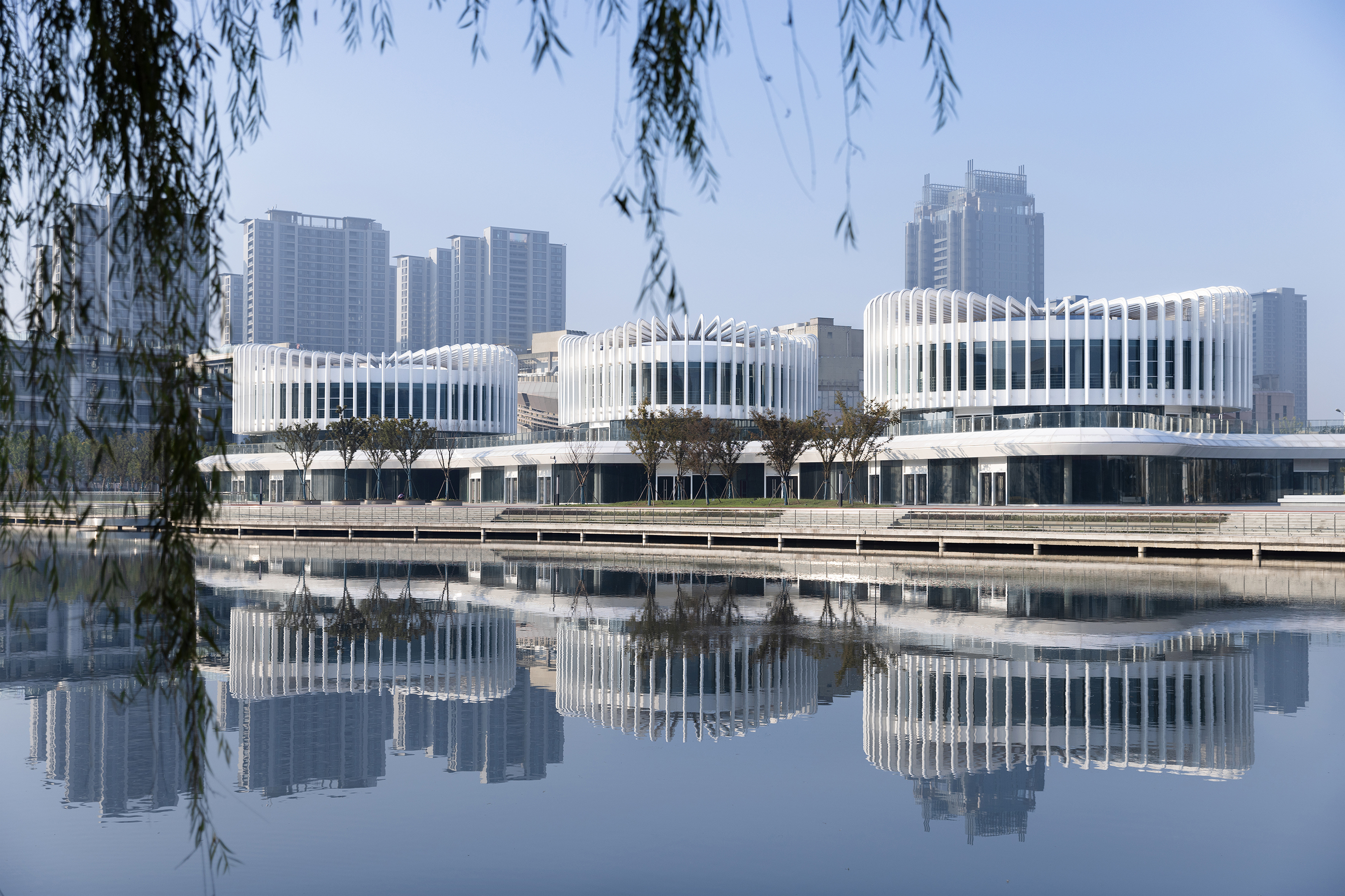 water-inspired architecture, riverfront buildings, urban design, modern Chinese architecture, tranquil environments, architectural aesthetics, public spaces, innovative structures, landscape and architecture, iconic projects