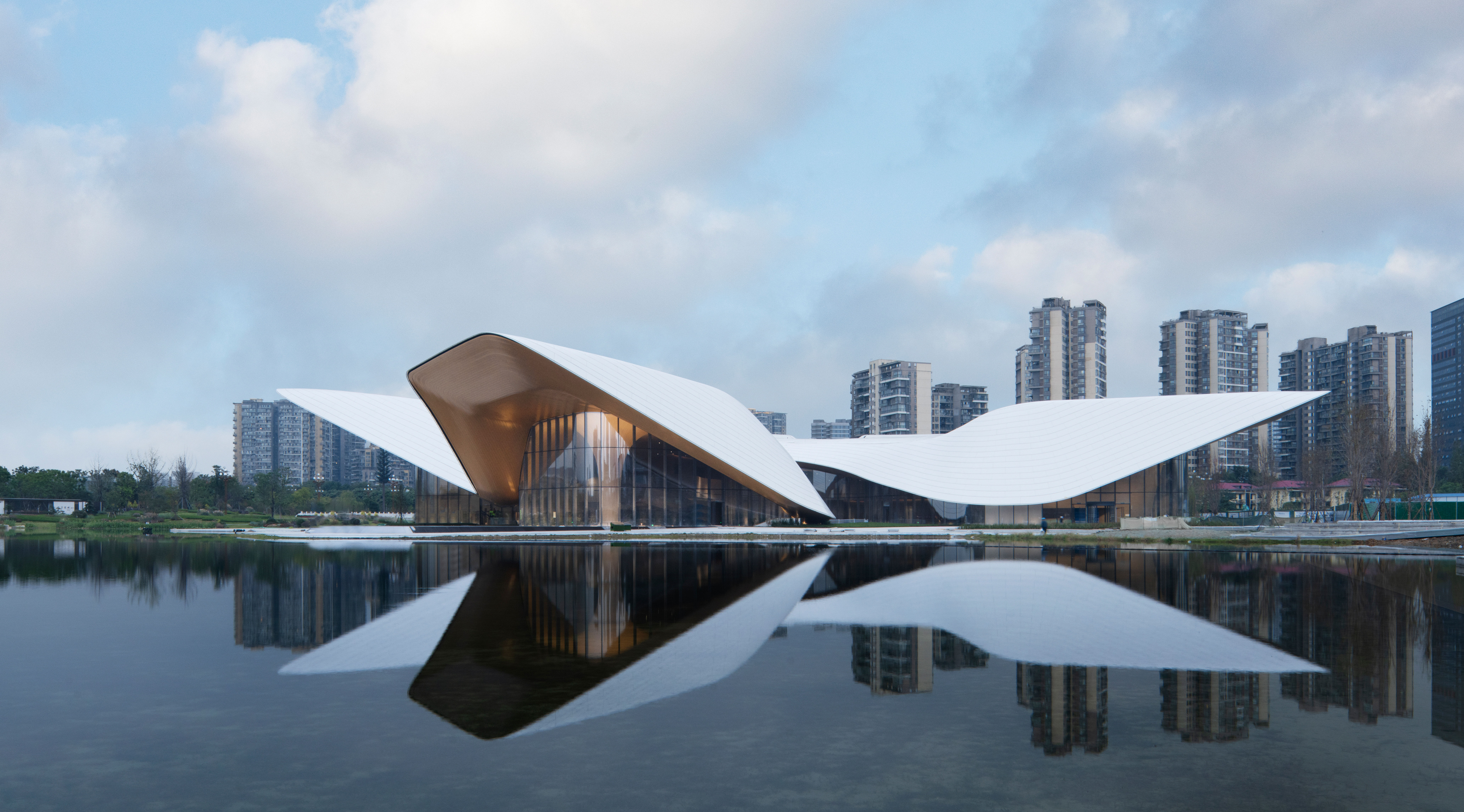 water-inspired architecture, riverfront buildings, urban design, modern Chinese architecture, tranquil environments, architectural aesthetics, public spaces, innovative structures, landscape and architecture, iconic projects